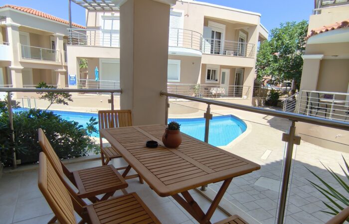 Balcony with pool and garden view at Relax Holiday House in Crete.