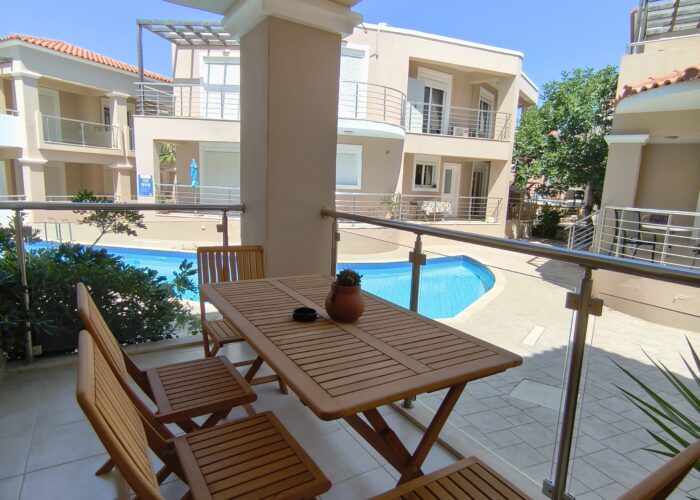 Balcony with pool and garden view at Relax Holiday House in Crete.