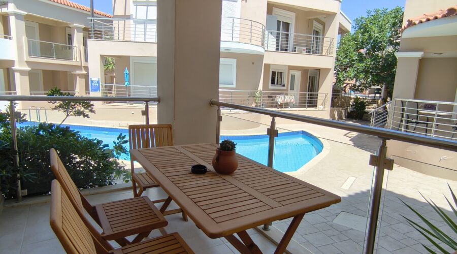 Balcony with pool and garden view at Relax Holiday House in Crete.
